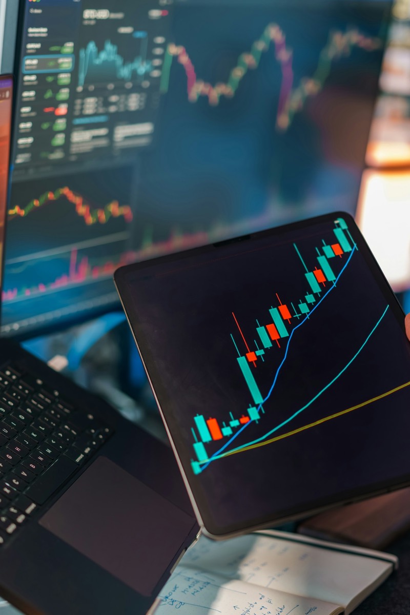 Research desk with multiple screens displaying stock charts